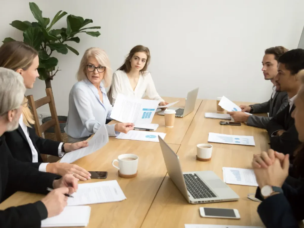 Committee members reviewing documents and discussing common property management, illustrating the governance role of an Owners Corporation in Victoria.